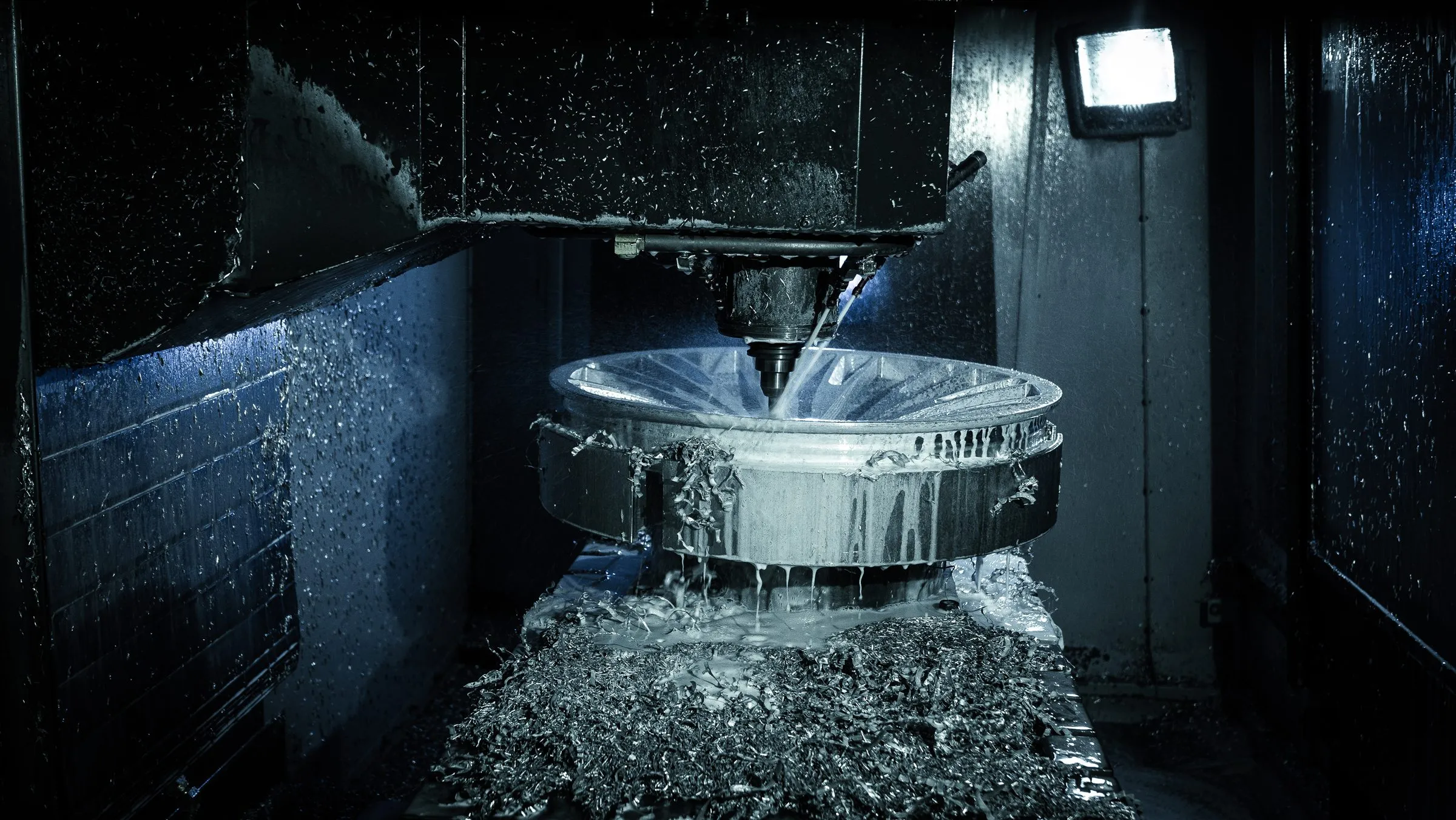 A forged wheel being machined inside a five-axis CNC at the Avant Garde machine shop